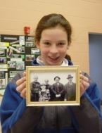 Dorchester resident holding photograph of her grandfather and great-great-grandparents