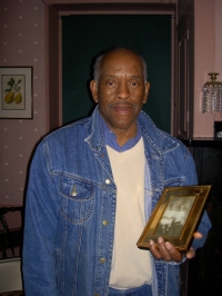 Dorchester resident with photograph of himself and his older sister as little children